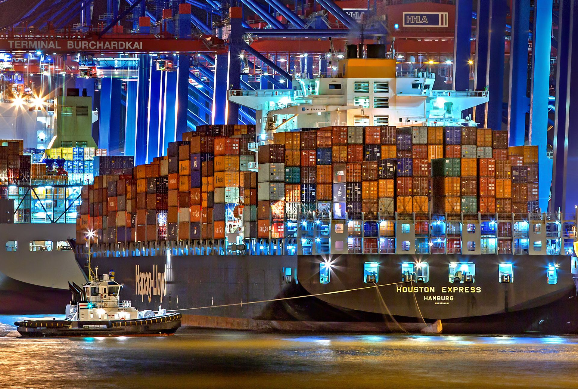 Night-time container vessel at an international port, representing global commodity trade
